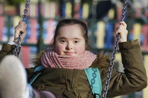Downs Syndrome girl on a swing